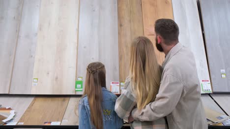 Family looking at wood flooring options in a store