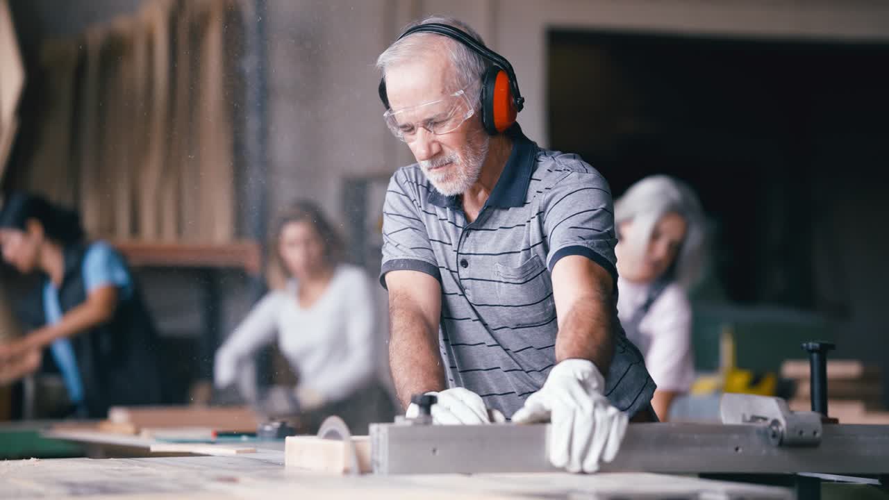 Skilled Carpenter Cutting Wood with a Circular Saw in a Workshop