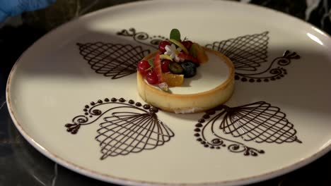 chef hands putting cheesecake on plate.