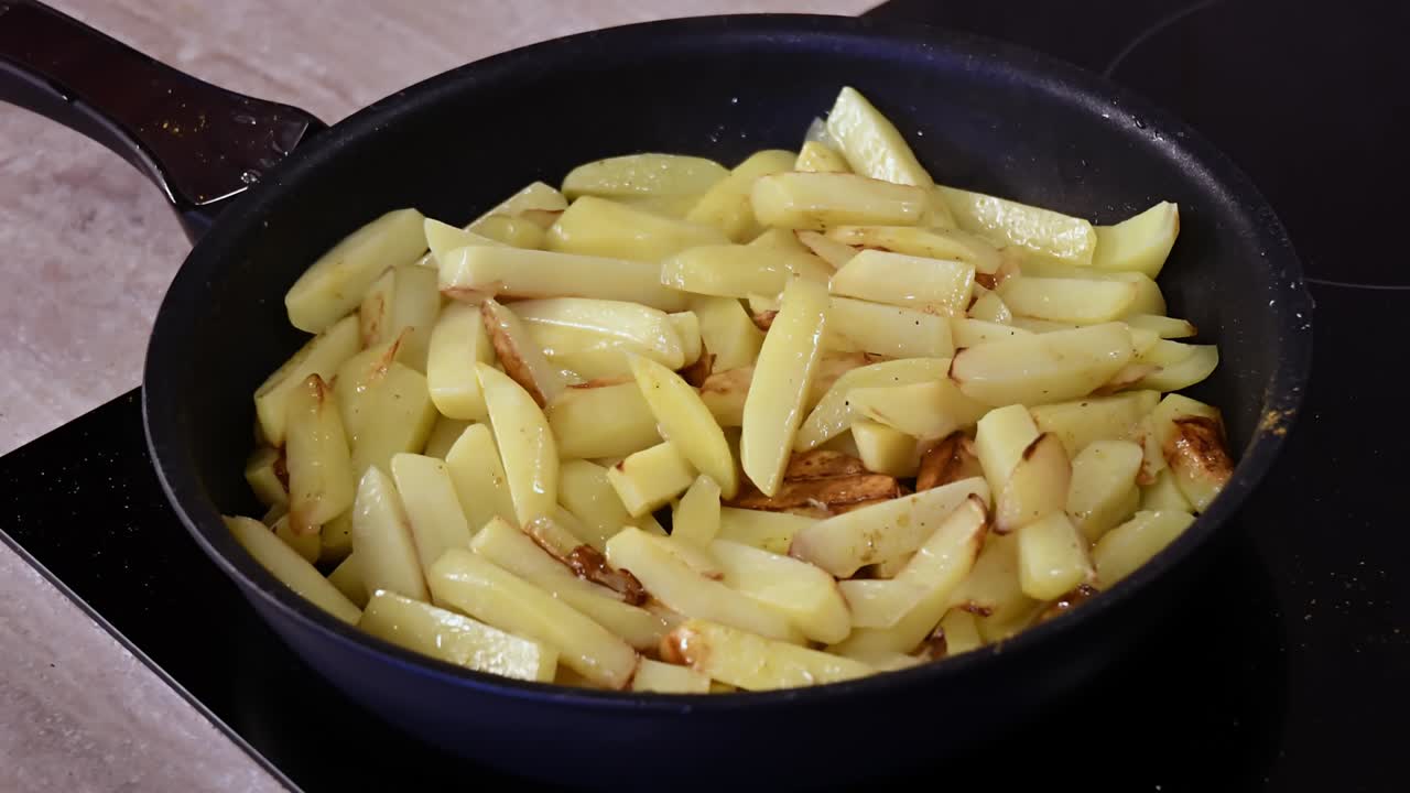 Time lapse frying homemade French fries in pan on kitchen stove
