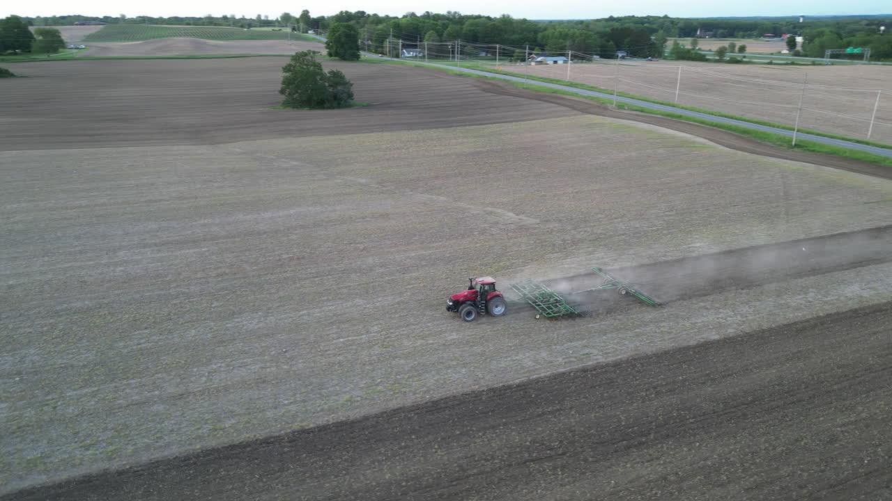 Aerial View Of The Tractor Plowing A Field Drone Footage