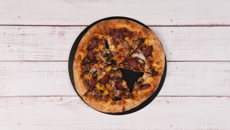stop motion animation of delicious pizza on wooden background, flat lay
