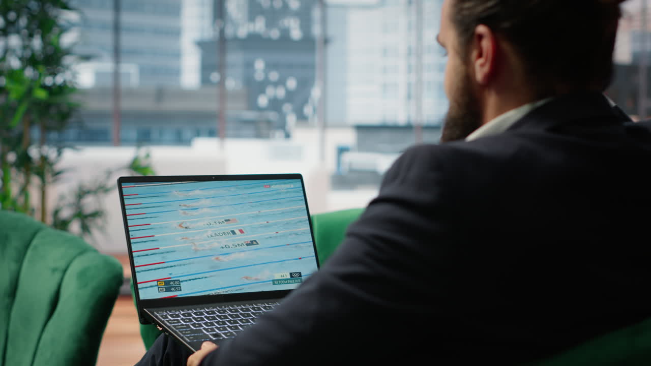 Vertical Video Bucharest, Romania - July 30th 2024 - Businessman watching Olympics live stream