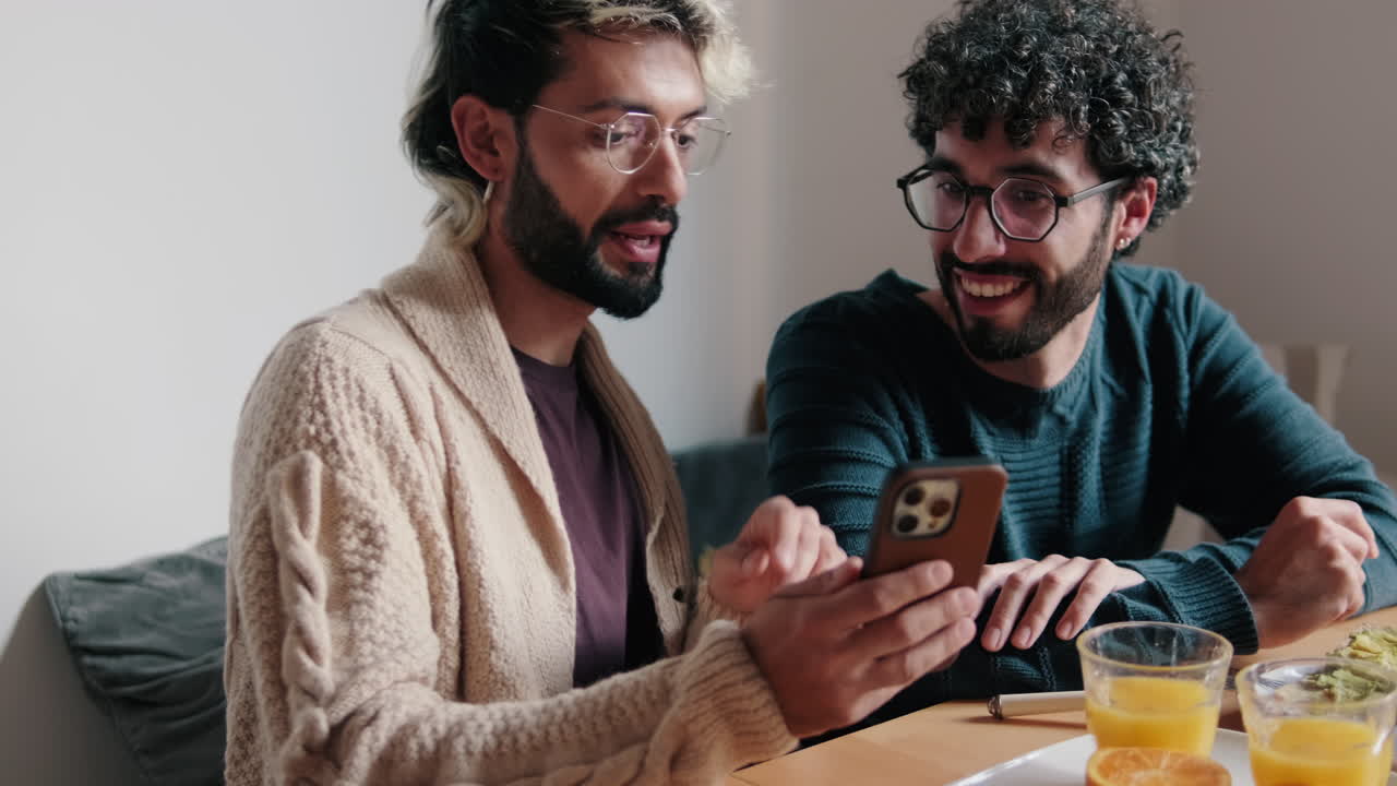 Gay Couple Enjoys Breakfast and Phone at Home
