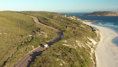 Excellent-Aerial-Shot-Of-An-Rv-Driving-On-Great-Ocean-Drive-Towards-The-Beach-In-Esperance,-Australia