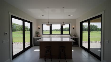 wide pull-back shot of a basement bar with white countertops and abundant natural light