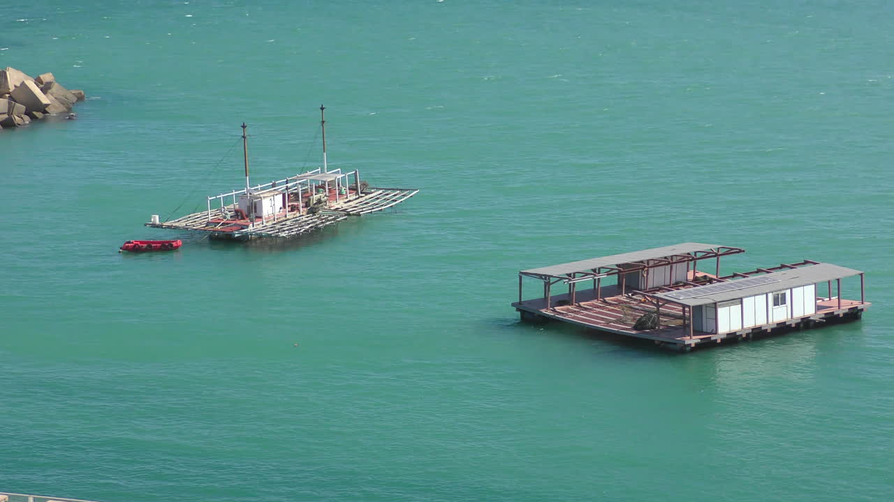 There are several fish farms in a harbor basin