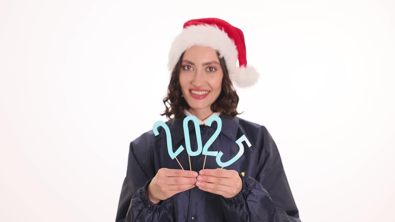 Woman in Santa Hat Holding 2023 Numbers for New Year Celebration