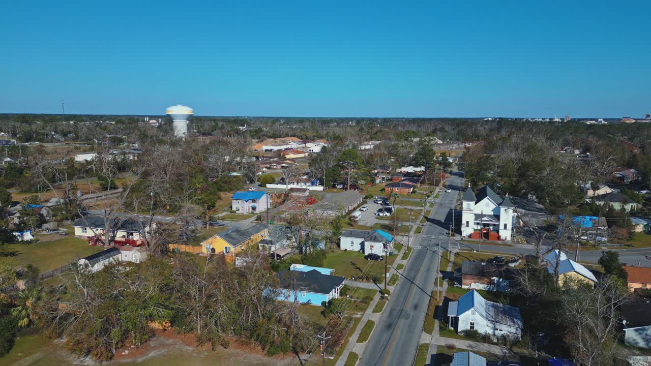 Aerial view of american suburb neighborhood in Valdosta City, Georgia. Sunny day with blue sky and church building. Small town in autumn.