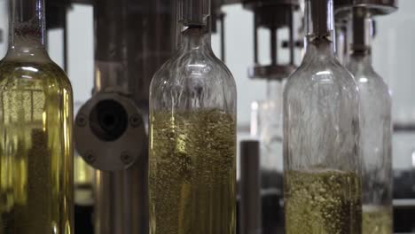 white wine bottling line with bottles turn in and filling