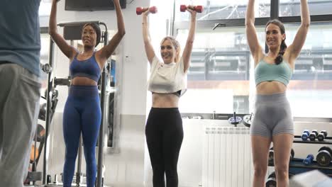 women lifting weights in a gym