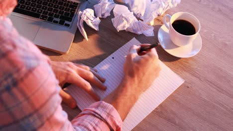 male executive writing on paper at his desk 4k