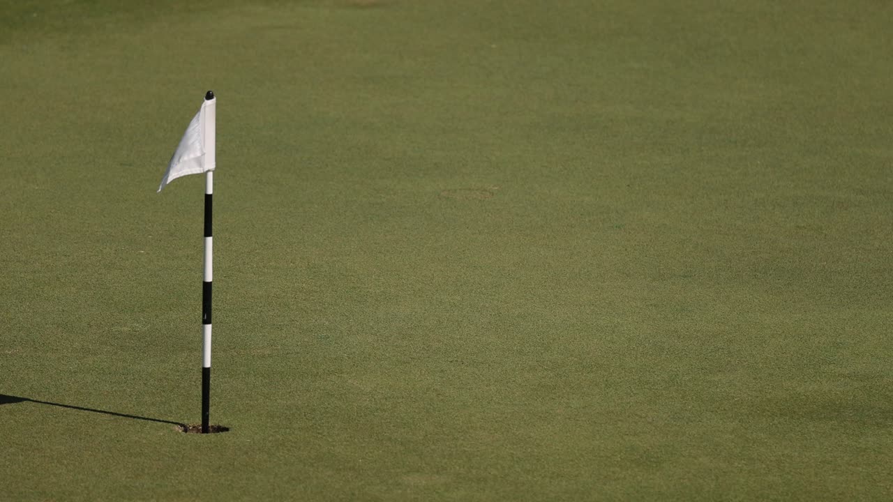 A golf flag waving back and forth