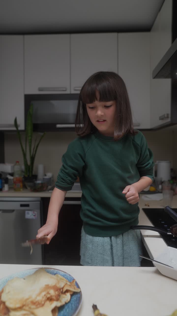 Child Cooking Pancakes in Kitchen