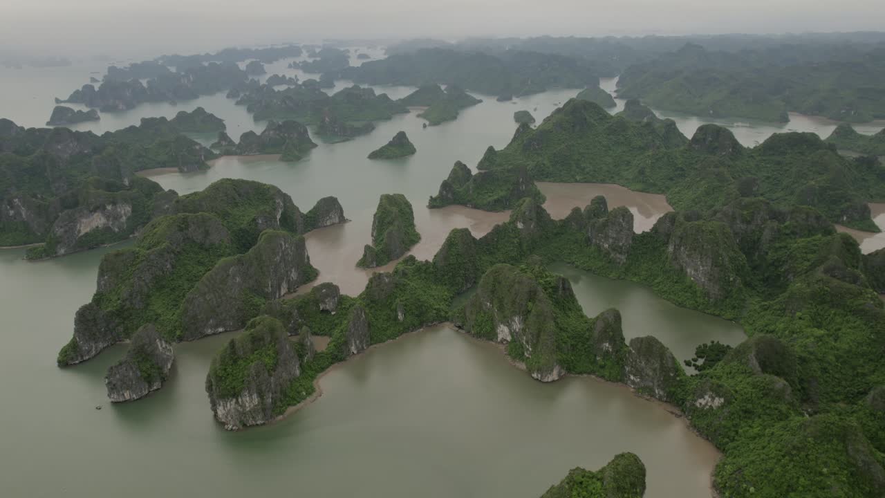 aerial - Halong Bay's limestone islands and emerald waters, surrounded by misty atmosphere. Vietnam