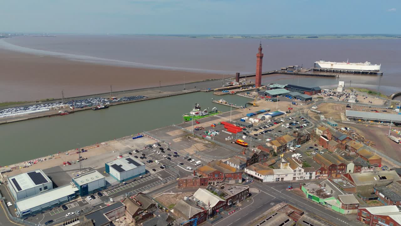 Aerial drone view of Grimsby Harbour with shipping containers and lighthouse in England