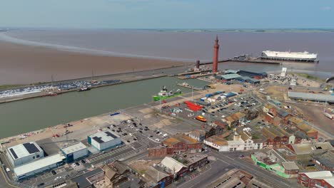 aerial drone view of grimsby harbour with shipping containers and lighthouse in england