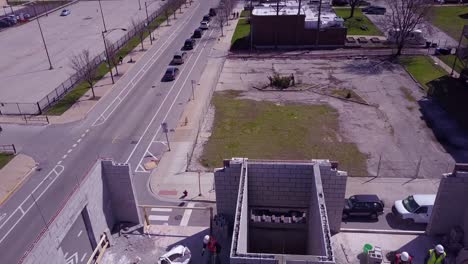 Aerial-over-workers-on-top-of-a-building-at-a-construction-site-2