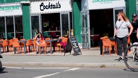 motorbikes and people outside a cocktail bar