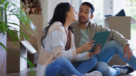 Couple,-pointing-and-tablet-in-new-house