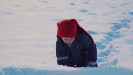 Determined-young-boy-pulling-his-sled-up-the-hill-in-the-snowy-landscape-in-Norway-during-Christmas