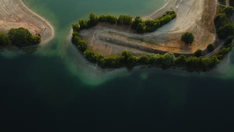aerial view of lakeside park with beach and trees