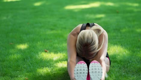 tired woman resting after outdoor workout. sport woman doing stretching exercise