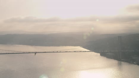 bridge on bosphorus and cars on it in sunset.