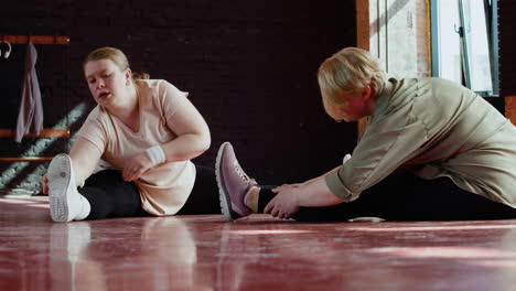 women stretching indoors