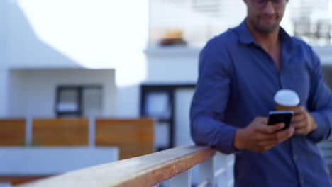 Handsome-man-sending-a-text-and-enjoying-coffee-4k