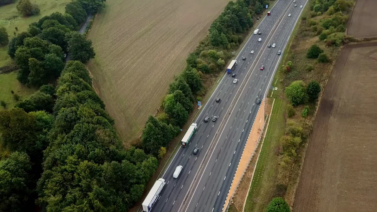 Drone above M1 Motorway with light traffic panning from south to north