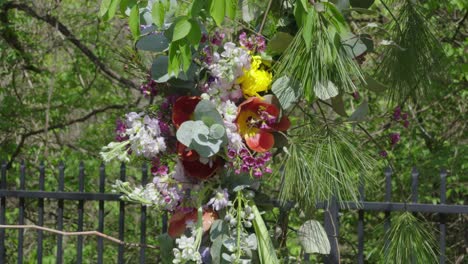 Fresh-mixed-garland-of-flowers-handing-outside-on-trees-for-wedding-ceremony