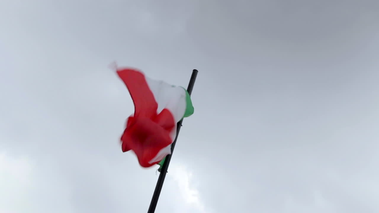 Italian Flag Waving In The Wind Attached To Pole. Low Angle