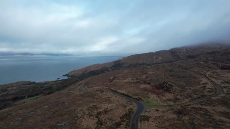 ireland epic remote road leading across barren mountain drone view sheeps head west cork on a winter afternoon