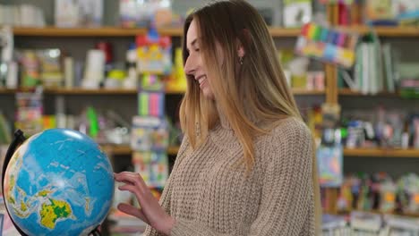 beautiful girl looking at a map of the world