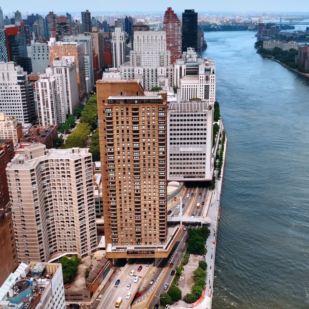 Footage above the buildings under which the highways pass on. Amazing New York architecture on the waterfront of the city