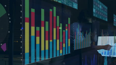 animation of data processing against diverse man and woman discussing over a computer at office