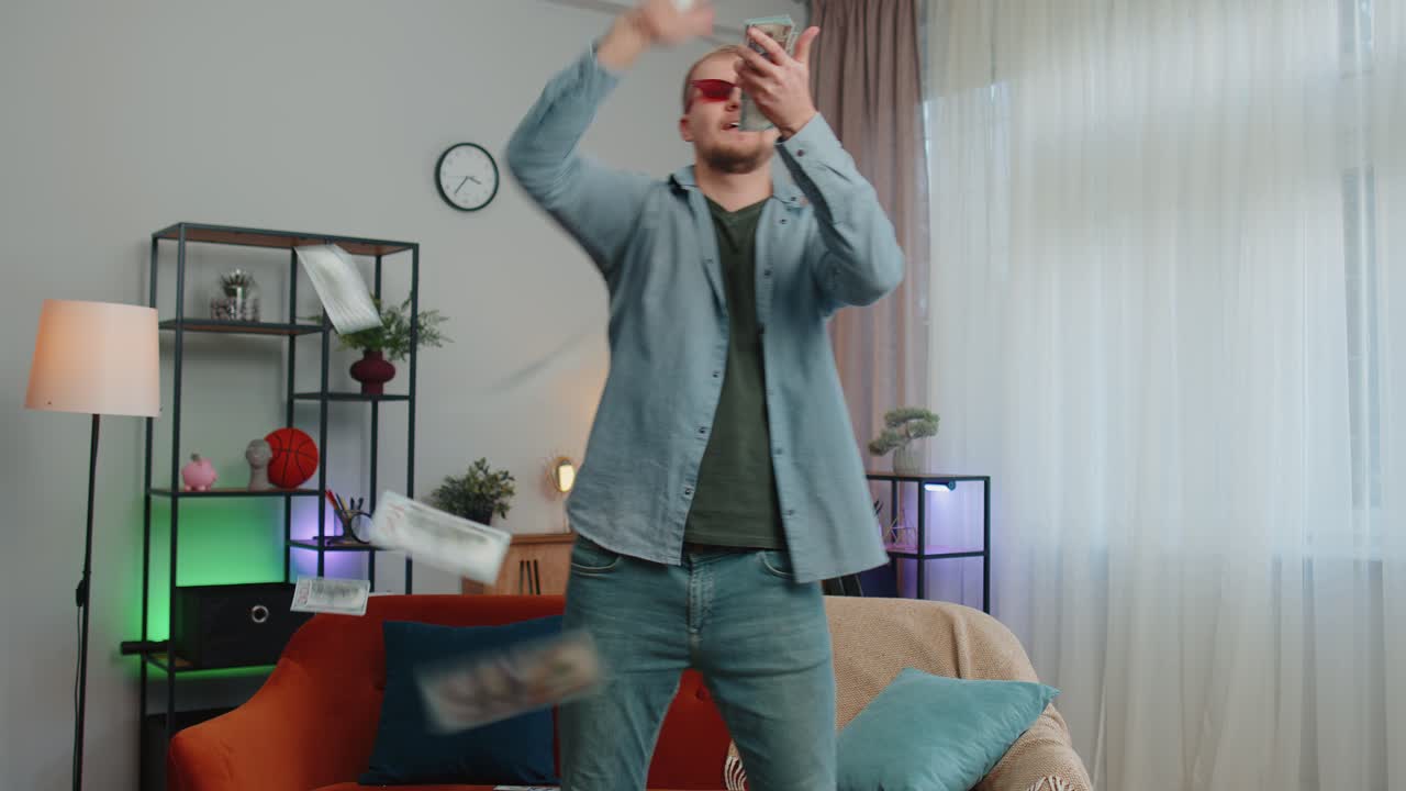 Young successful rich businessman throwing money cash banknotes falling dollars lottery winner