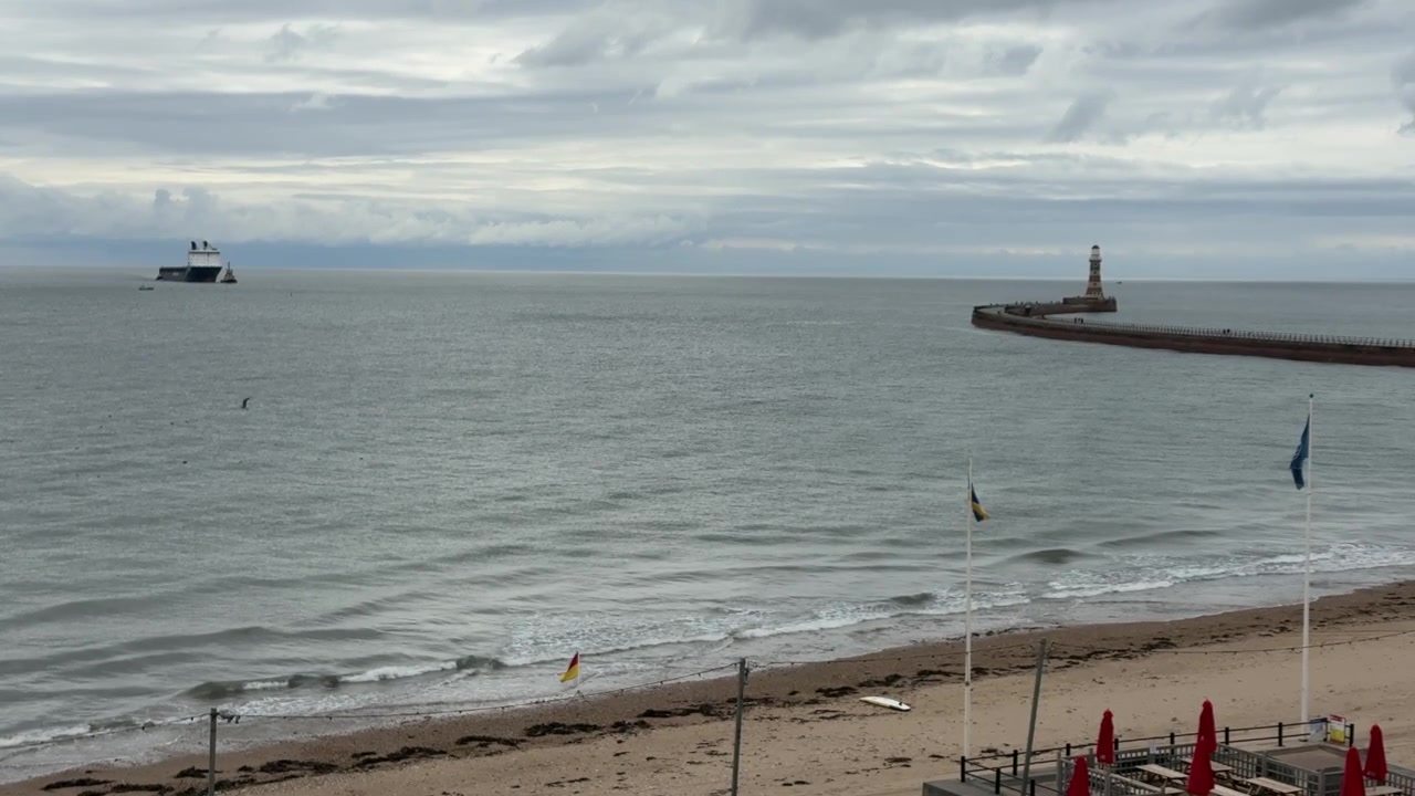 Ship Approaching Roker Pier Lighthouse and Sunderland Harbour from the North Sea, England