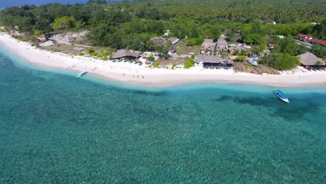 tourists walking along the beach in gili meno