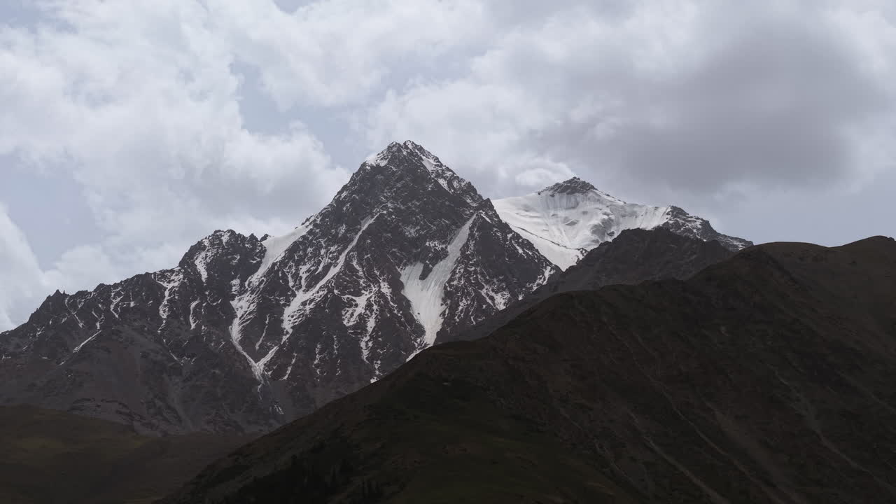 Snow Rock Peaks Of Tian Shan Mountains Of Kyrgyzstan. Aerial Close-up Shot