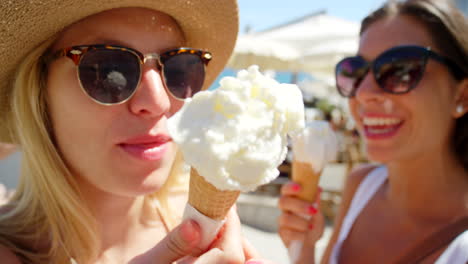 two friends enjoying vanilla ice cream cones