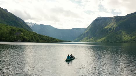 kayakers paddling toward a mountain