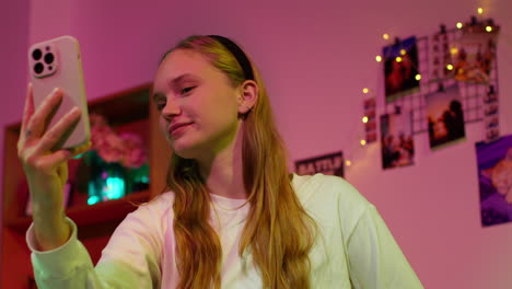 young woman taking a selfie with her phone