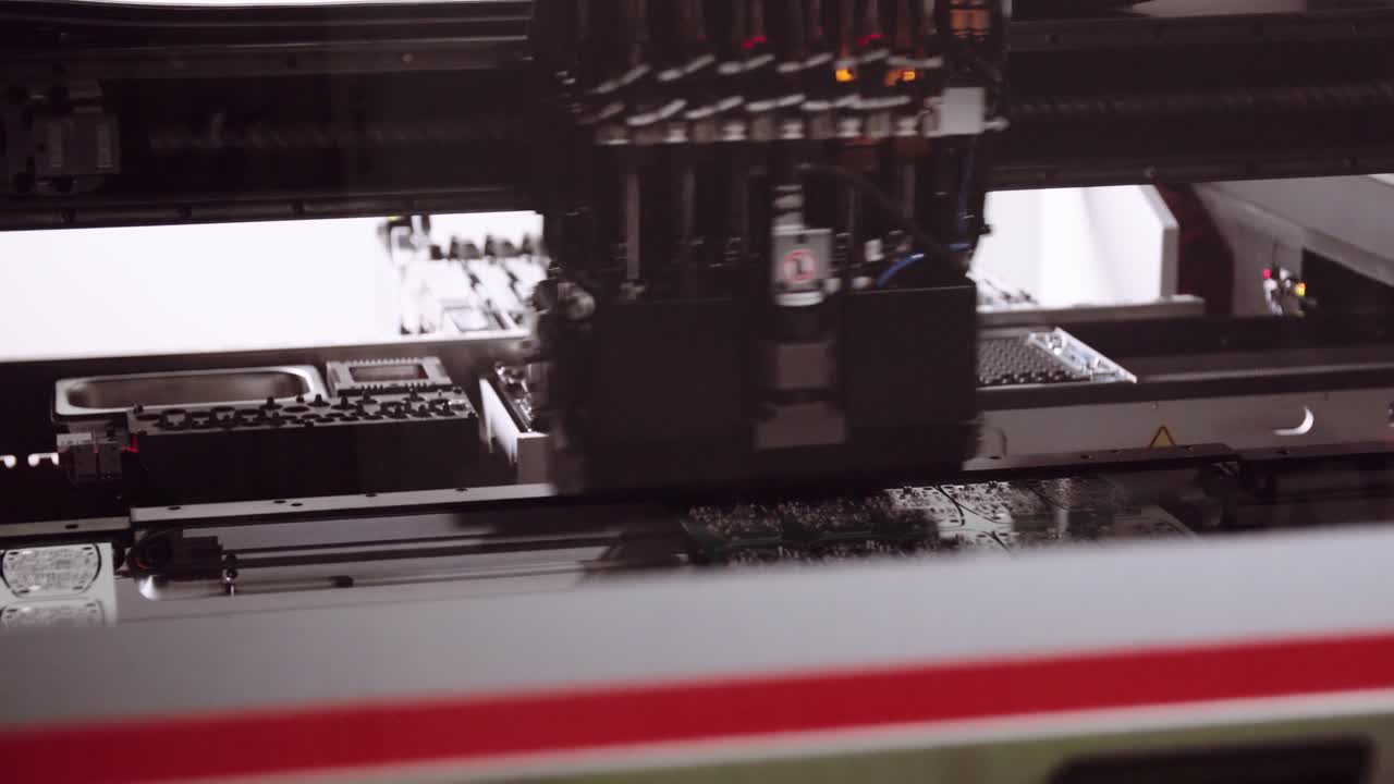 Close up of Robotic pick and place machine assembling electronic PCBs