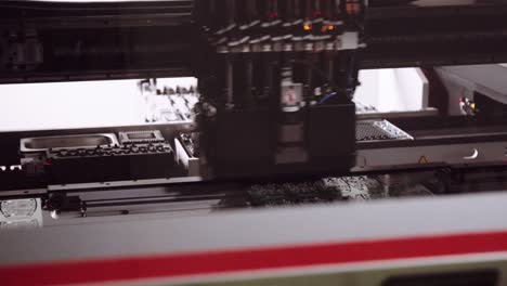 close up of robotic pick and place machine assembling electronic pcbs