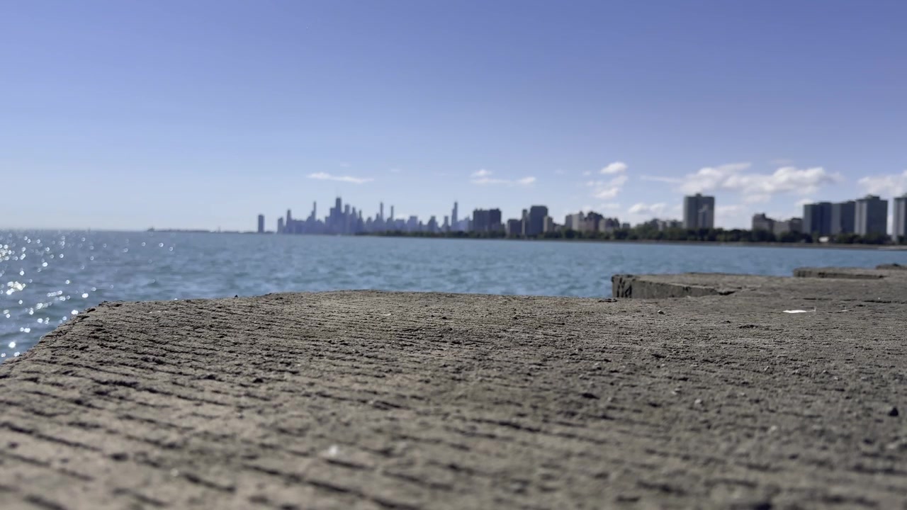 Scenic footage of Lake Michigan with gentle waves and the beautiful Chicago shoreline creating a peaceful waterfront atmosphere.
