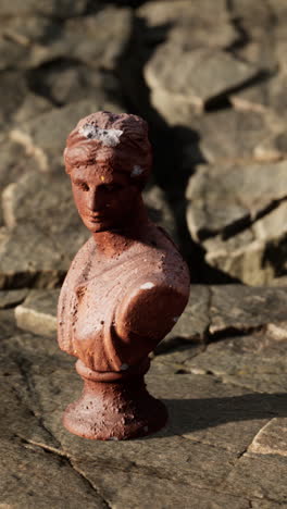 weathered terracotta bust of a classical woman