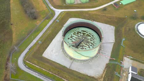 aerial view of oil storage tank with rusted external floating roof