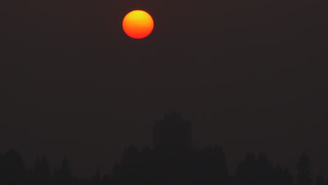 downtown vancouver at night - yellow orange moon due to wildfire smoke in north america - view from capitol hill, burnaby, bc - wide shot